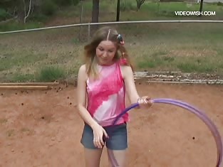 Teen Plays With Her Hula Hoop in the Back Yard